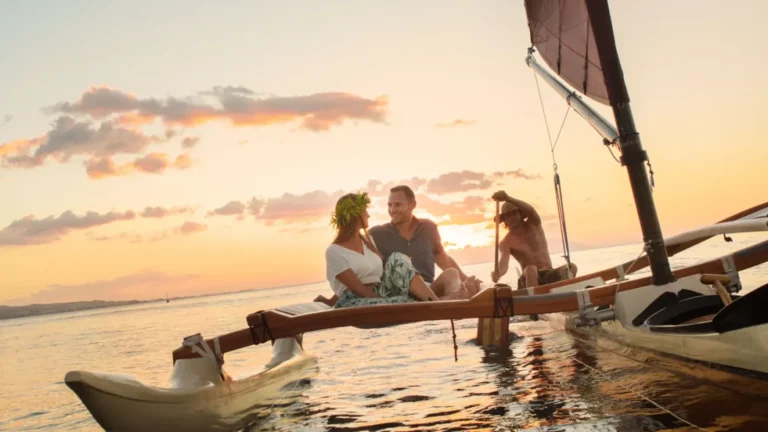 Traditional Outrigger Sunset - Local guides paddle a flower-adorned outrigger canoe through golden afternoon light
