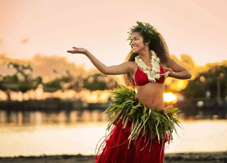 Polynesian Dance Performance - Traditional dancers in flower headdresses share stories through graceful movements at sunset