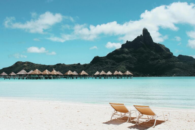 Mount Otemanu Rising - Bora Bora's majestic peak emerges from morning mist, framed by swaying palms and crystal-clear waters